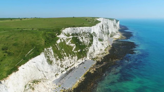 Aerial view of famous white cliffs of Dover, clear blue sky - English Channel, England, Great Britain from above, 4k UHD