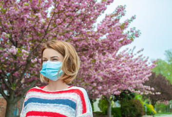 Allergy. Woman wearing protect mask from pollen allergy