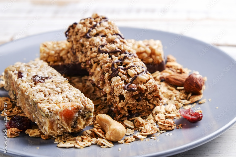 Wall mural Top view of various healthy granola bars (muesli or cereal bars). Set of energy, sport, breakfast and protein bars isolated on white background