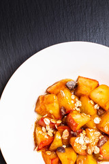 food concept Fried Red organic Apple chopped with cinnamon,sugar and butter in the white dish