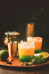 Fototapeta premium Orange cocktail decorated with lime