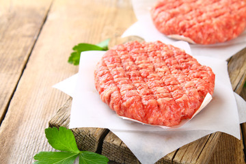 Raw minced meat for home made grill burgers cooking with spaces and herbs.