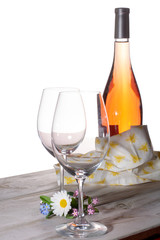 Rose wine served with two glasses and flowers copy space close up