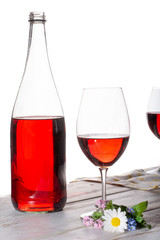 Rose wine served with two glasses and flowers copy space close up