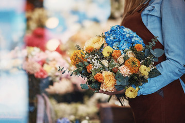 Young girl with bouquet in the store