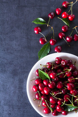 Fresh red ripe cherries on white plate