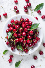 Fresh red ripe cherries on white plate