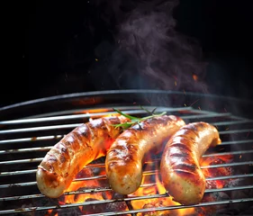 Plexiglas foto achterwand Grilled sausages on grill with smoke and flame © Alexander Raths