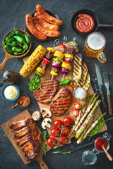 Grilled meat and vegetables on rustic stone plate