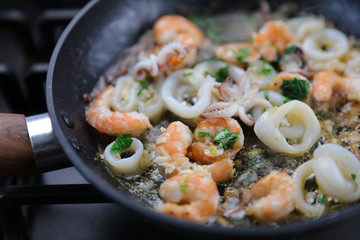 frying seafood in pan