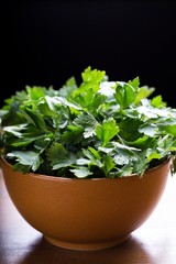 Fototapeta premium Green parsley. Fresh green parsley on the wooden table