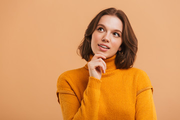 Portrait of a pensive young woman in sweater looking away
