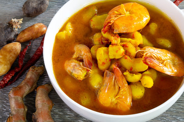 Yellow curry prawn and Local vegetable (Thailand call Mun kee noo) in white bowl on gray wooden table Thai food  delicious © tatui1761