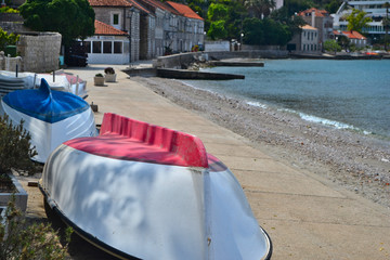 Two boats, red and blue, on the beach by the Adriatic sea in Croatia