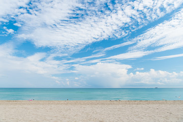 Fototapeta na wymiar Sea beach with white sand and blue water in miami, usa. Seascape on cloudy sky. Summer vacation on tropical resort. Discovery or adventure and wanderlust