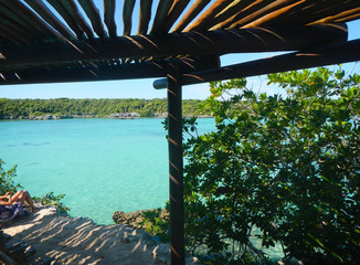 beautiful caribbean bay view from under a wooden veranda