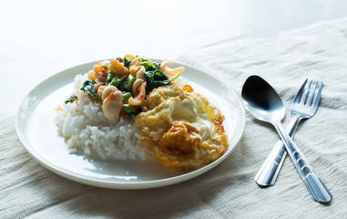 Kao Pad Kra Prao or Thai rice with squid and basil.Thai style food, Egg fried rice close