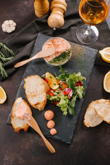 Chicken homemade liver paste or pate in glass jar with sliced whole grain bread
