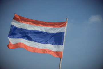 picture of waving Thai flag of thailand with blue sky background., king bhumipol