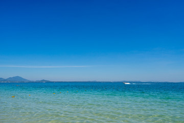 Fototapeta na wymiar scenic of white speed boat in sea and clearly blue sky