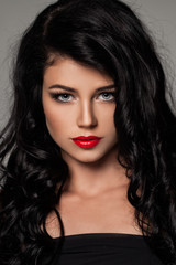 Fototapeta premium Portrait of Sexy Brunette Woman with Curly Hair. Beautiful Female Model Face