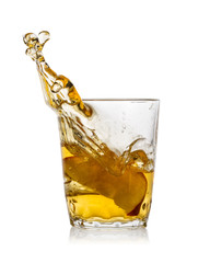 Glass of apple juice with splash from red apple slice