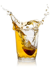 Splash of apple juice with slice of red apple in transparent gla