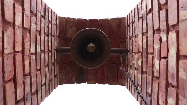 Undershot of old bell swinging