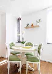 Modern kitchen table with dining chairs and wooden floor. Hardwood floor