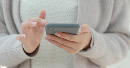 Close up of using mobile phone in city