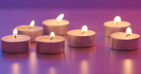 Many small flaming candles burning