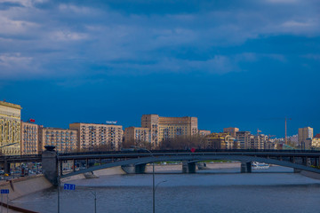 Outdoor panoramic view of Moscow and bridge over the Moskva River in conecting modern skyscrapers of Moscow-City. Landscape and cityscape of Moscow in cloudy sky