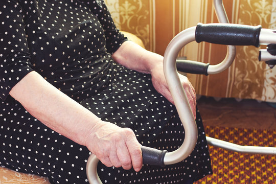 Elderly Woman Using A Walker At Home.