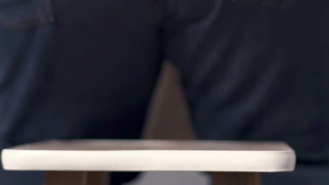 Huge buttock in jeans clumsily sitting on small stool, person with extra weight