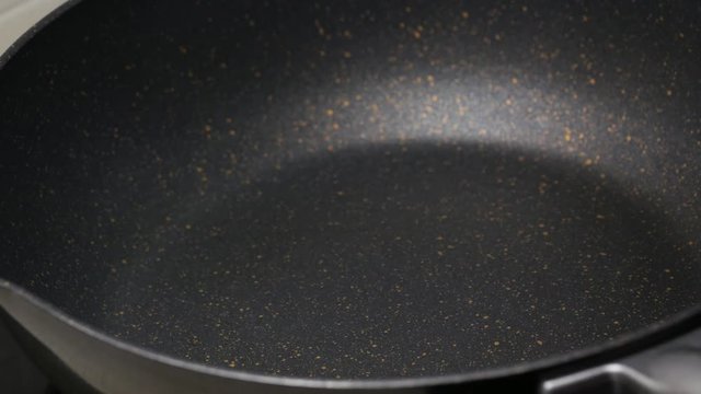 Pour the food palm oil into the black teflon pan. and wait for high temperature  before cooking food menu