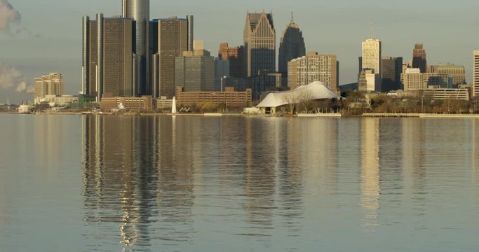 Tilt Up Reveal From Detroit River To Downtown Cityscape At Sunrise