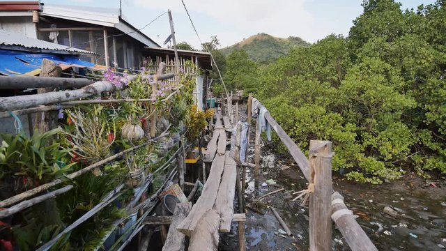 Houses in the Filipino slums for poor people. Wooden bridges from planks on high water. Poverty of people and families.