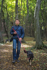 Man walking with dog in the forest