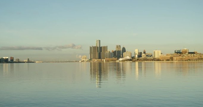 Wide Tilt Up Reveal From Detroit River To Downtown Cityscape At Sunrise