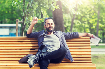 Obraz premium lifestyle, creativity, freelance, inspiration and people concept - creative man with notebook or diary sitting on city street bench