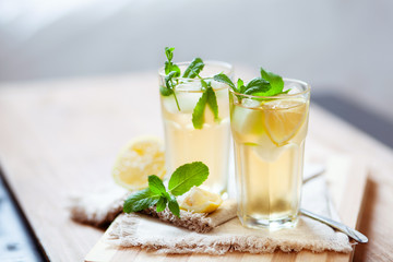 Refreshing summer drink with lemon, mint and ice copy space