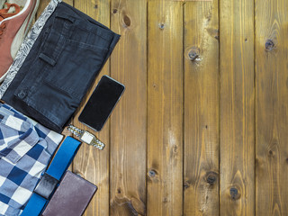top down overhead view of stylish men clothes accessories on a wooden background