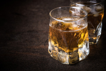 Whiskey with ice in glass