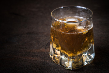Whiskey with ice in glass