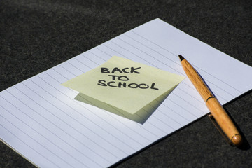 Yellow Sticky Note Memo Back To School On White Notebook Note Block Lines Wood Pen School Work Write