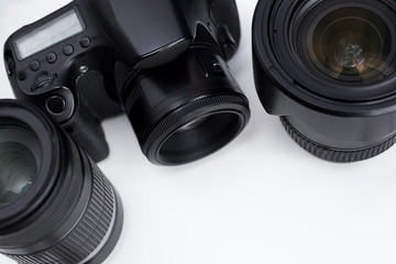 close up of dslr camera and lenses over white