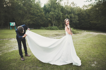 Young happy wedding couple outdoors funny portrait