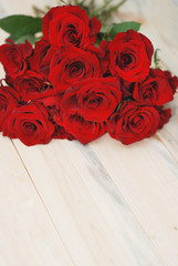 Red Rosess close up Isolated over Wooden Textured Background