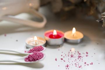  spa concept . pink bath salt with candle on the white background.