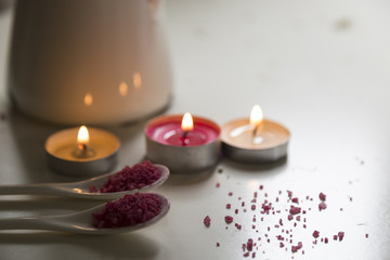  spa concept . pink bath salt with candle on the white background.